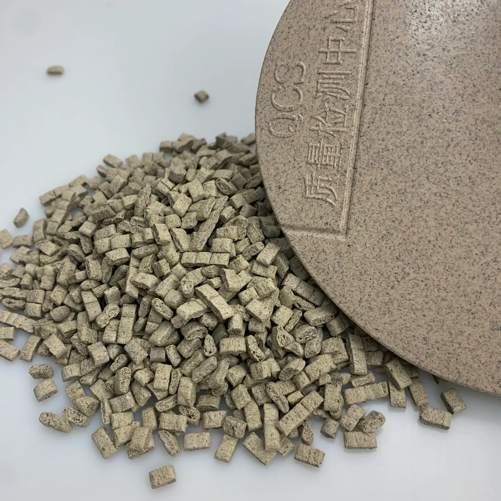 Close view of P179-CZML tea-fiber PP pellets and molded surface texture