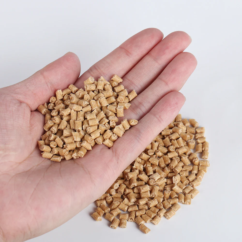 Red pine fiber PP masterbatch pellets held in hand
