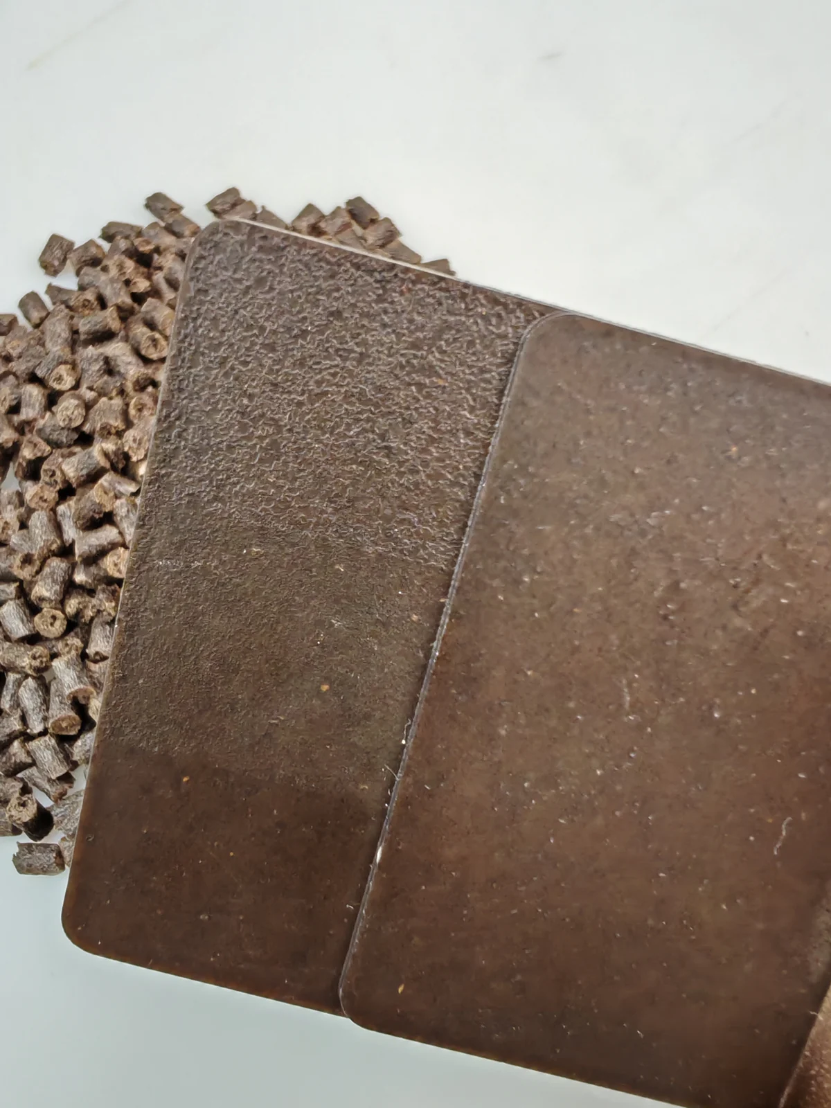 Close view of coffee fiber PP masterbatch molded sample plaques