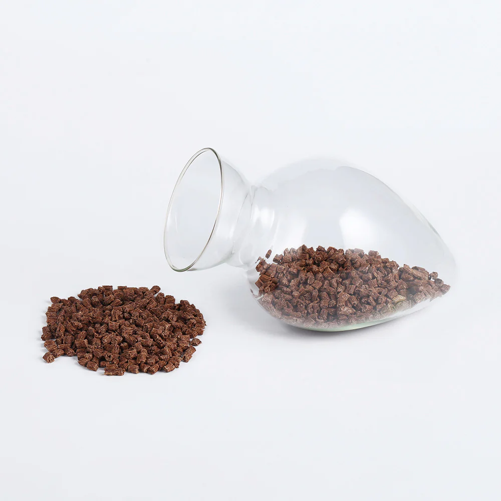 Coconut fiber PP masterbatch pellets in a laboratory flask