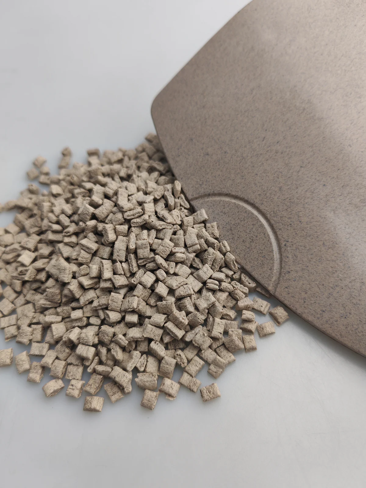 Tea fiber PP pellets beside a molded sample plaque