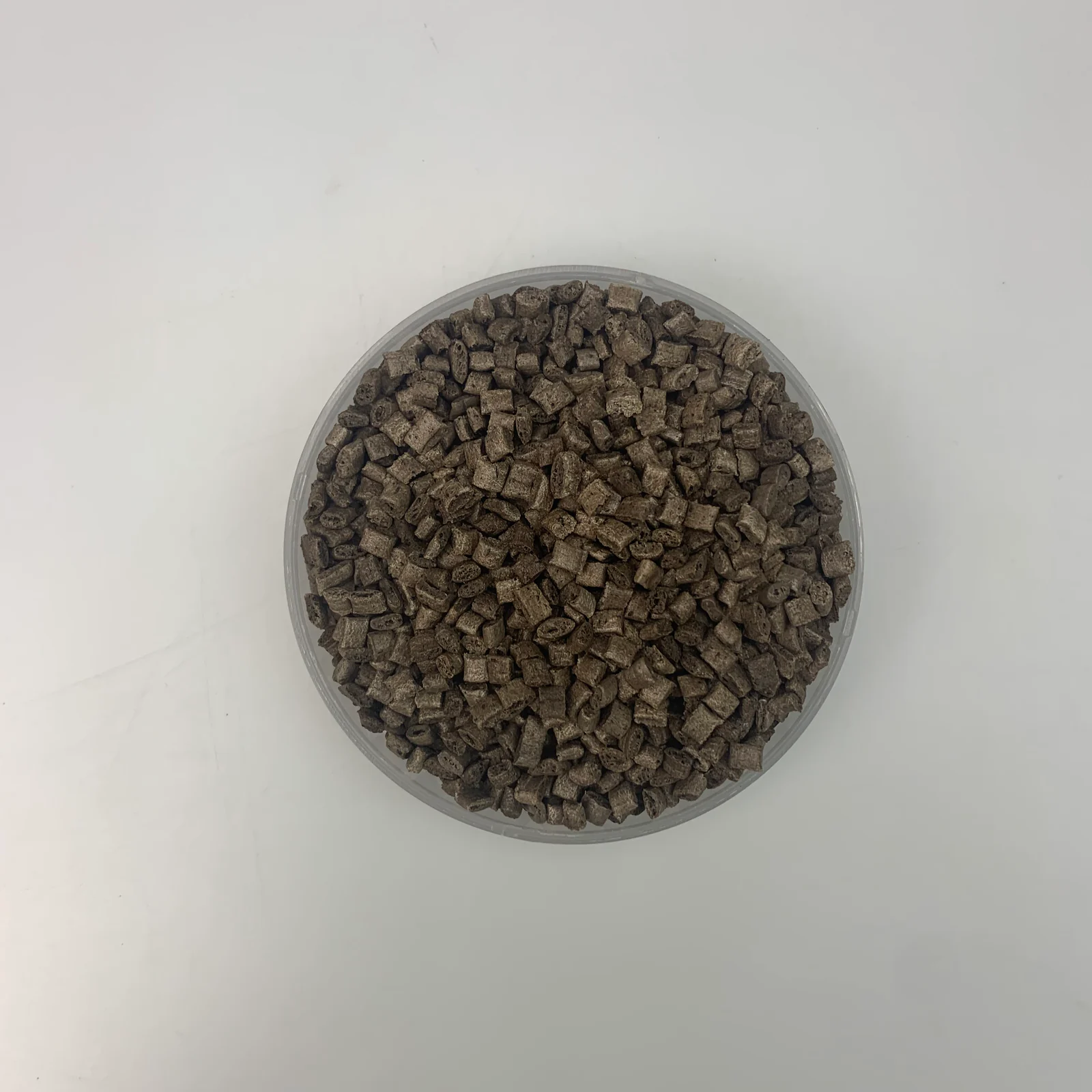 Coffee ground fiber ABS pellets in a sample dish