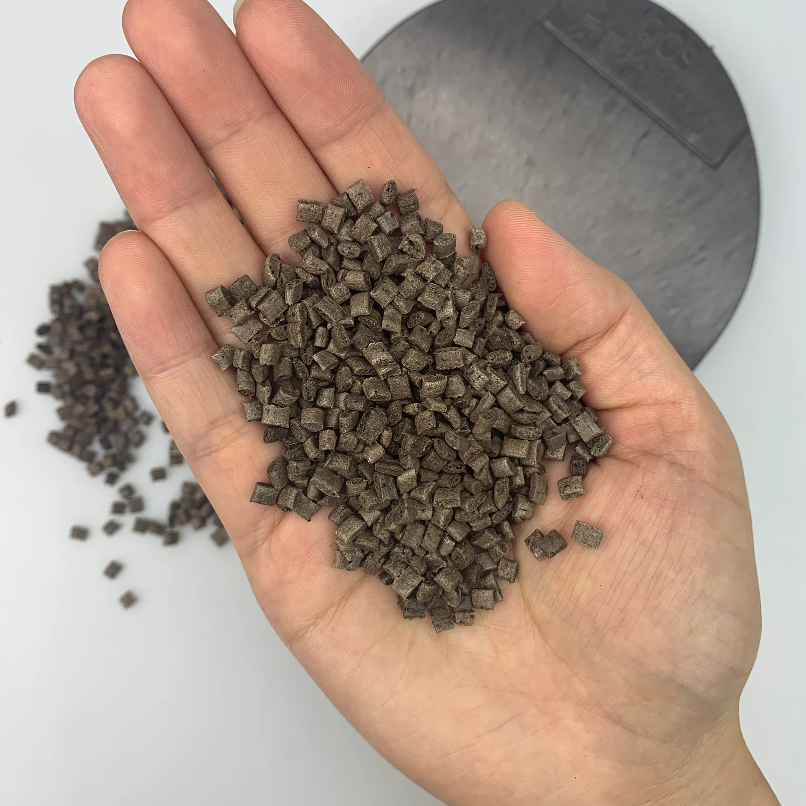 Coffee ground fiber ABS pellets held in hand