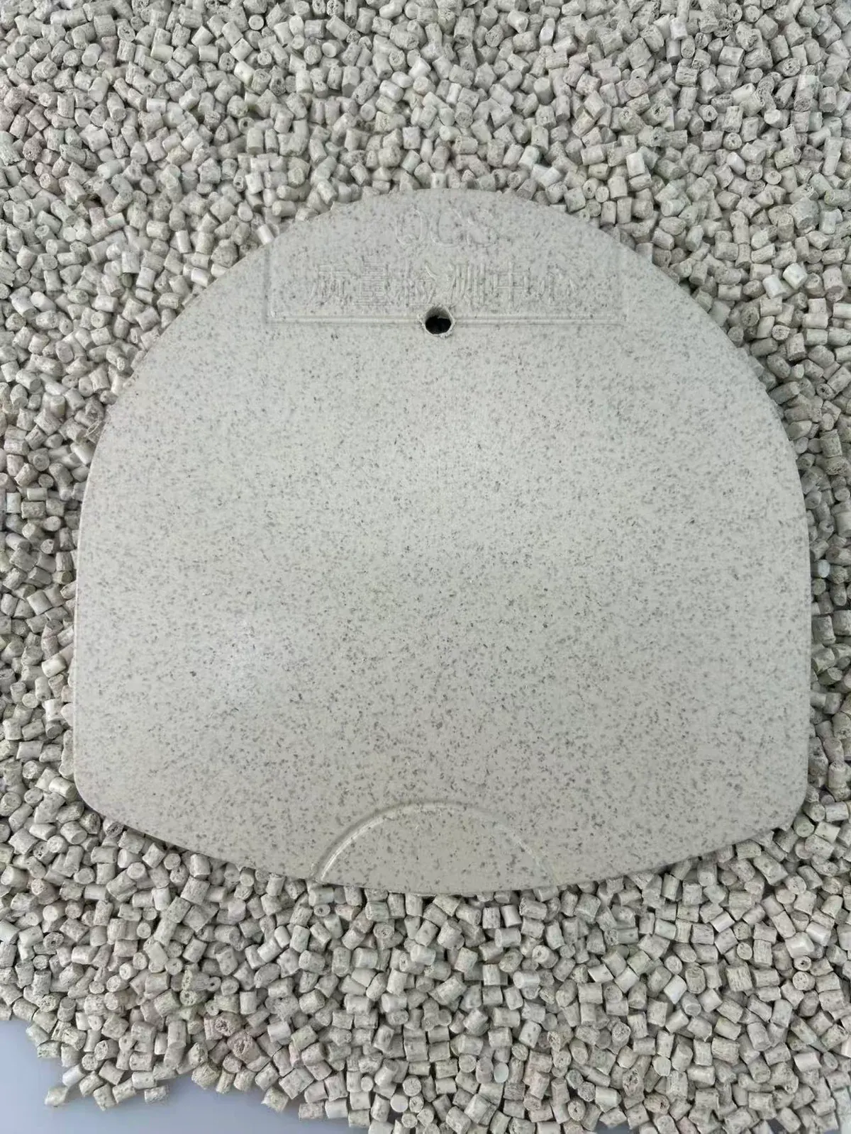 Cereal fiber ABS pellets with a molded sample plaque